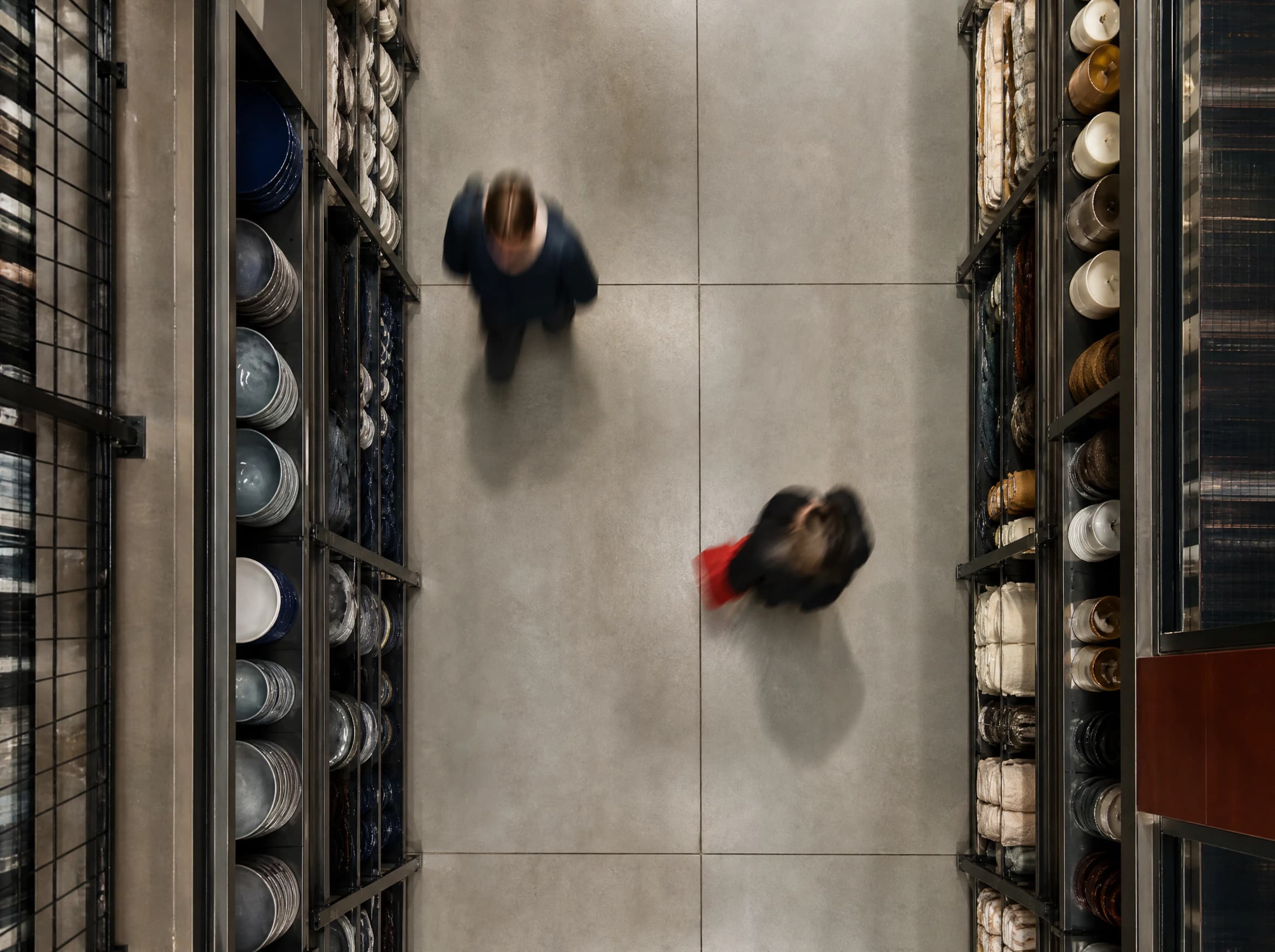 Overhead view of shoppers moving through a store aisle